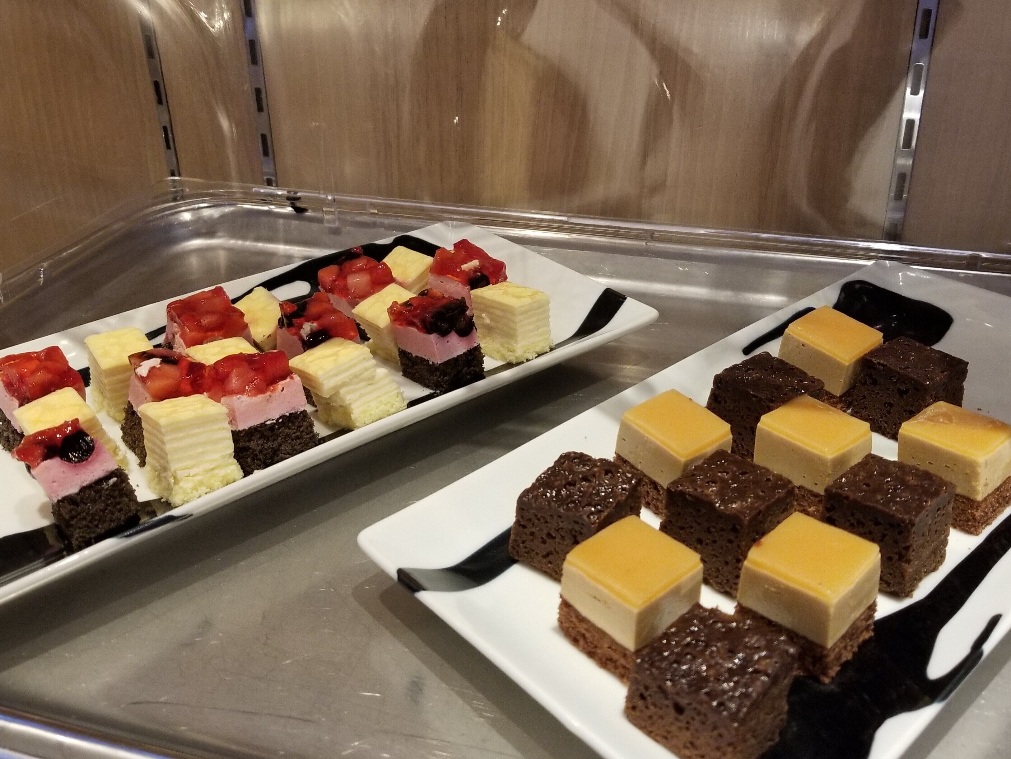 A tray of assorted desserts including cakes and cheesecakes.