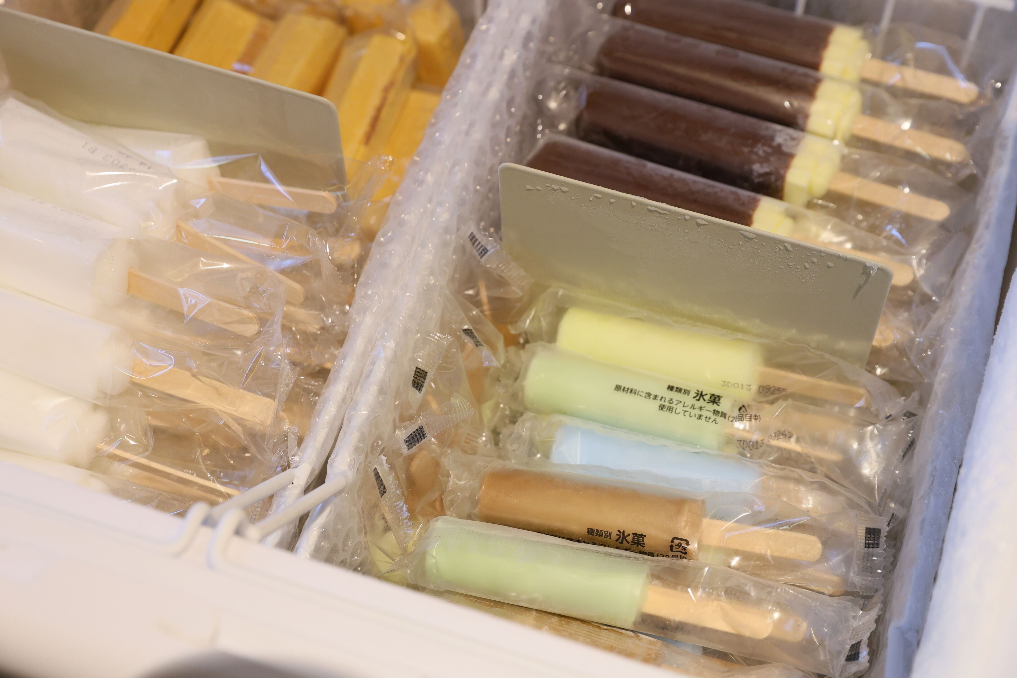 A storage box containing various packaged items, likely food or supplies, with different colors and sizes.