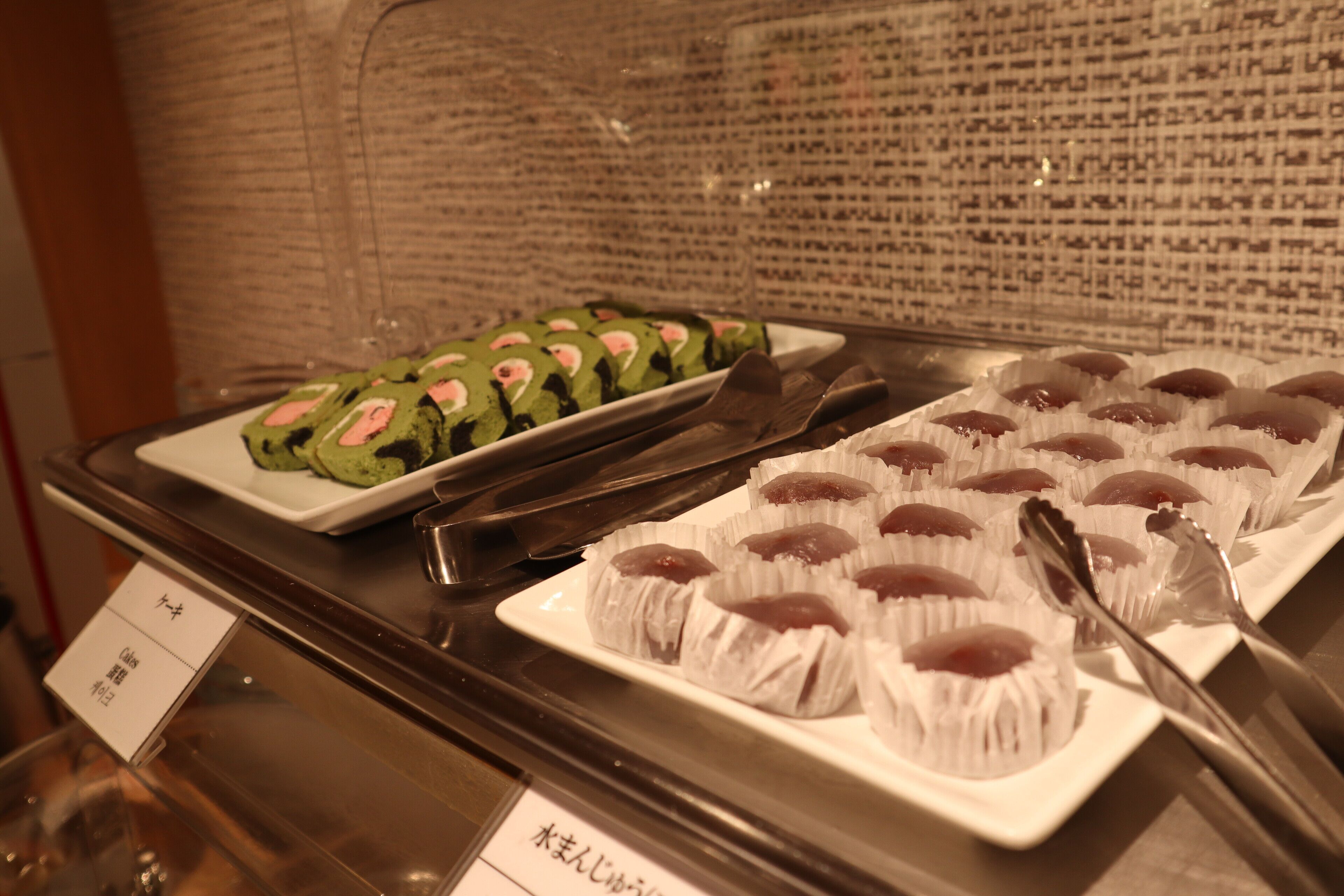 A buffet with various dishes, including sushi and other Asian cuisine.