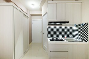 Studio | Private kitchenette | Fridge, stovetop, rice cooker, cookware/dishes/utensils - Studio at Green Pramuka City Serene Apartment Living By Travelio (Jakarta)