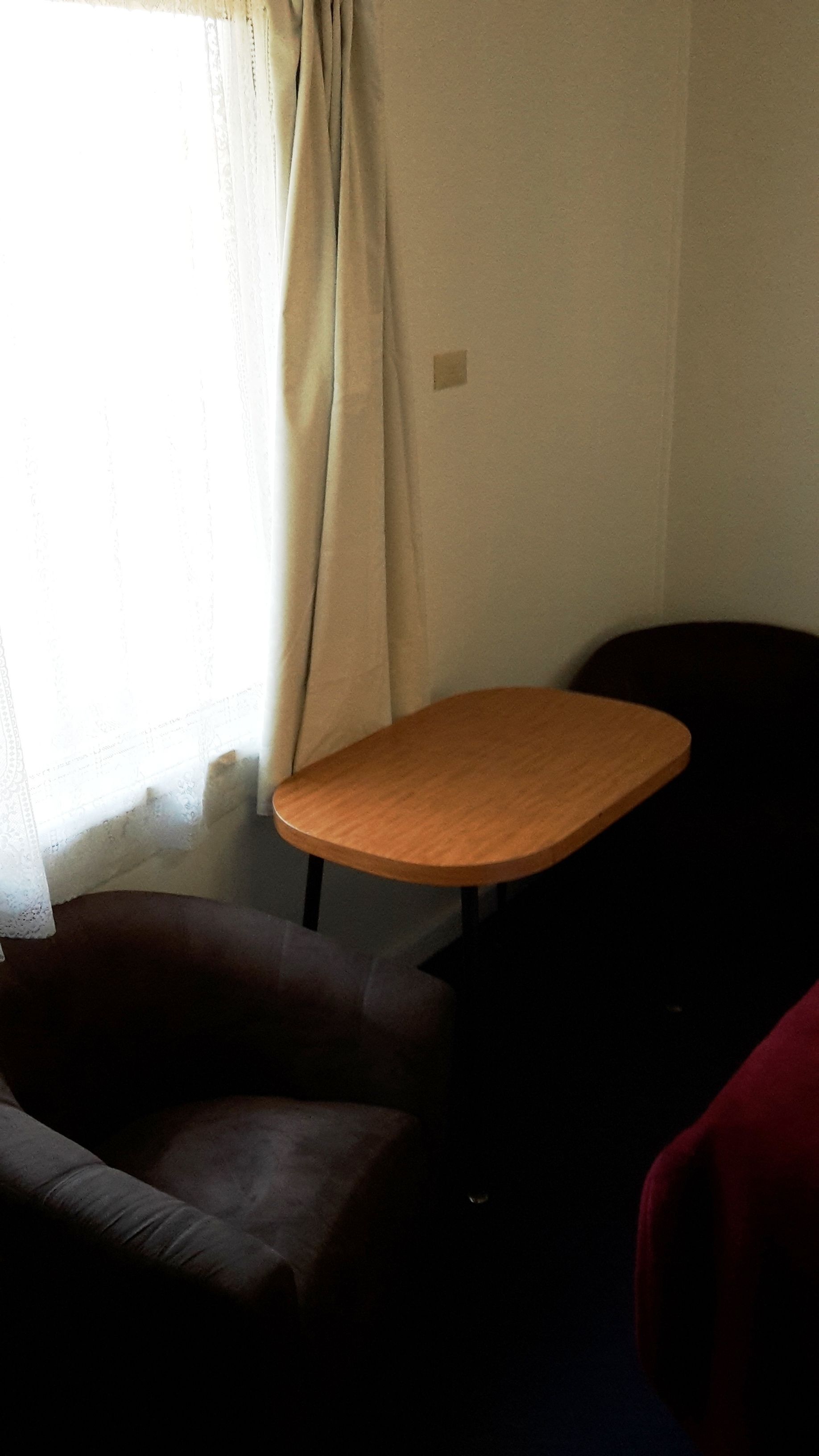 A room with a table, a chair, and a couch.