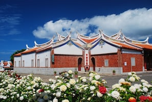 A traditional building with a red brick facade and ornate, curved rooflines.