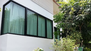 A modern building with large windows and a white exterior. - The Tree Madauwan (Ko Pha-ngan)