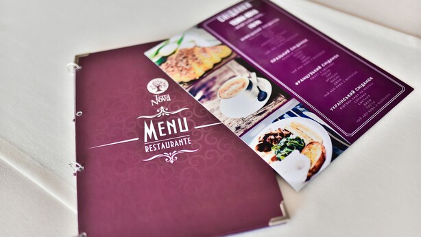 A menu booklet with a maroon cover and a purple menu page displaying food items. - Terra Nova Sport & Spa Hotel (Hatne)