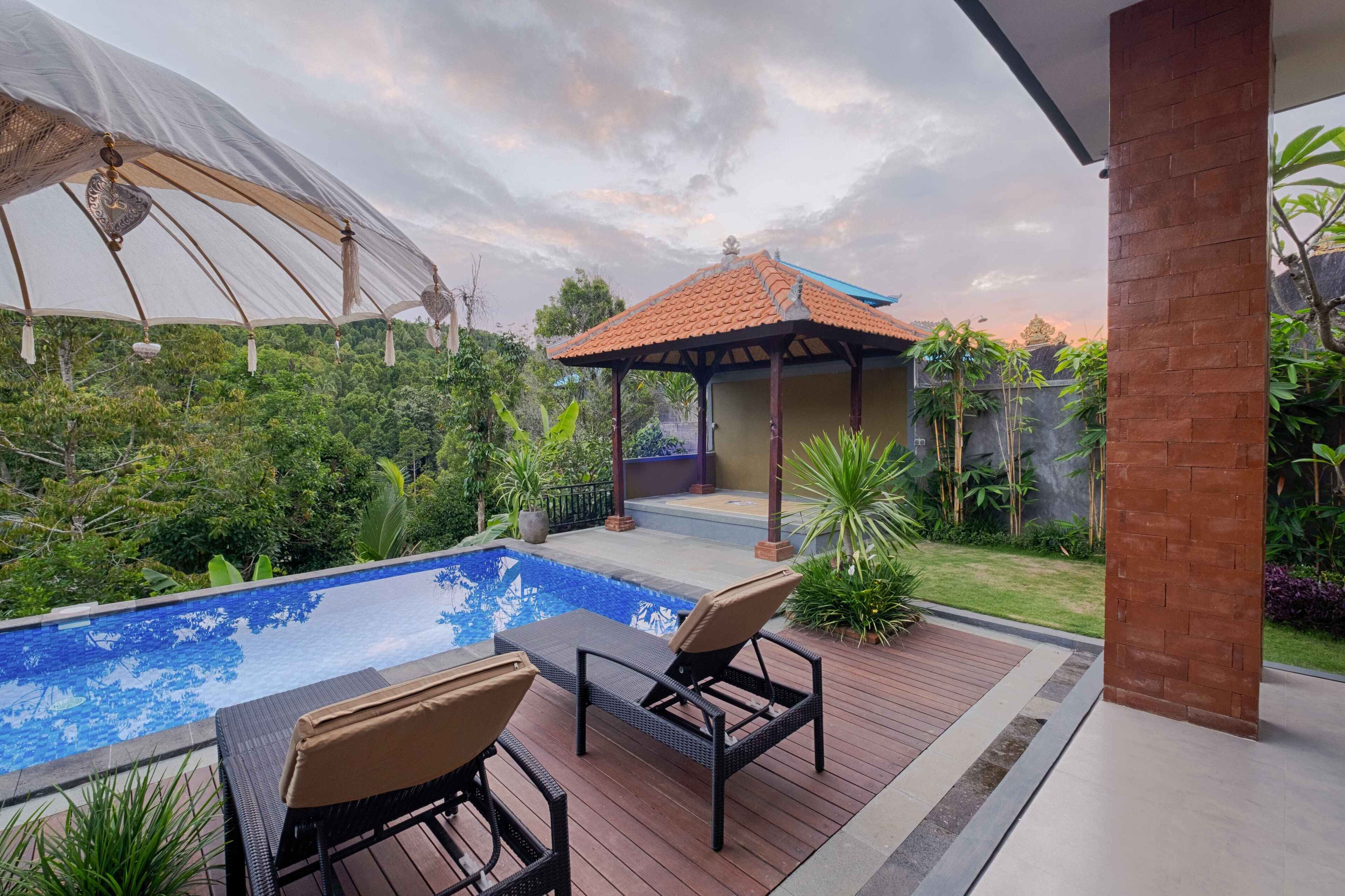 A pool area with lounge chairs and a gazebo.