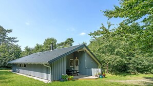 A small, single-story cabin with a sloped roof, a porch, and a chimney. - Gorgeous home in Dronningmølle (Dronningmølle)