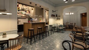Un restaurant avec des tabourets de bar, des tables et un sol à motifs.