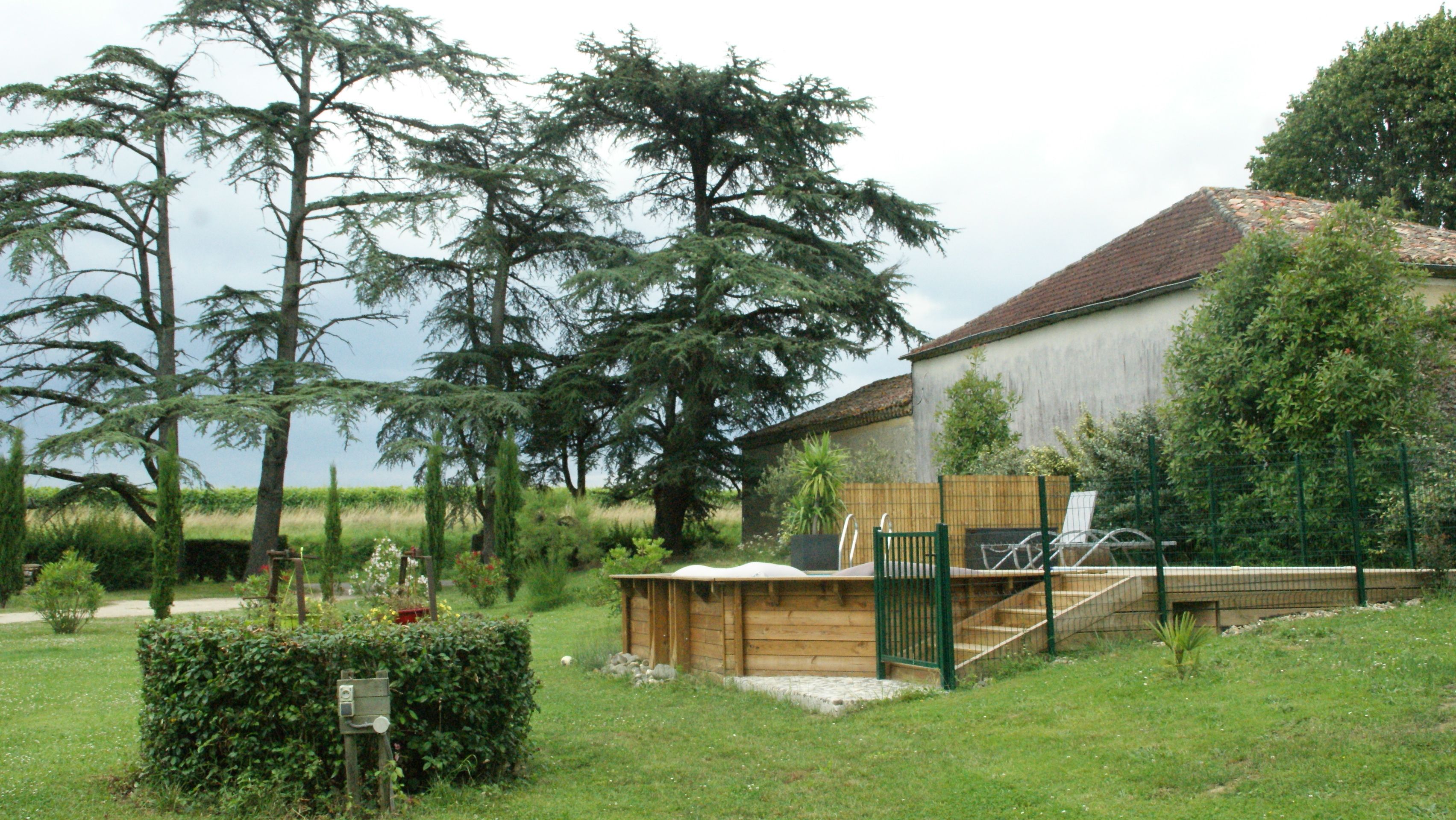 A rustic wooden cabin with a metal gate and stairs leading to a wooden deck.