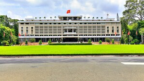 A large, modern building with a symmetrical facade, multiple windows, and a central entrance. - HANZ MinhVy Hotel (Ho Chi Minh City)