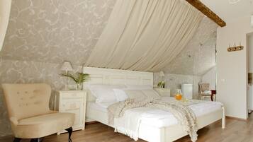 A bedroom with a bed, a chair, a nightstand, a lamp, and a mirror.