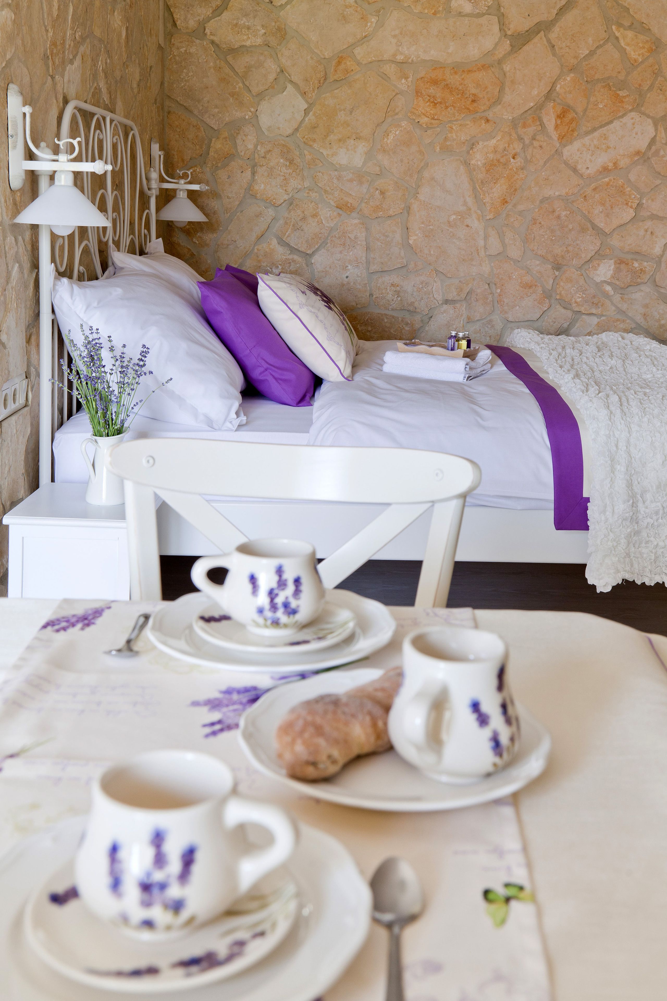 A neatly arranged breakfast table with a cup, saucer, and a pastry.