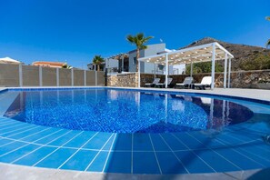 Outdoor pool, open 8 AM to 7 PM, pool umbrellas, pool loungers