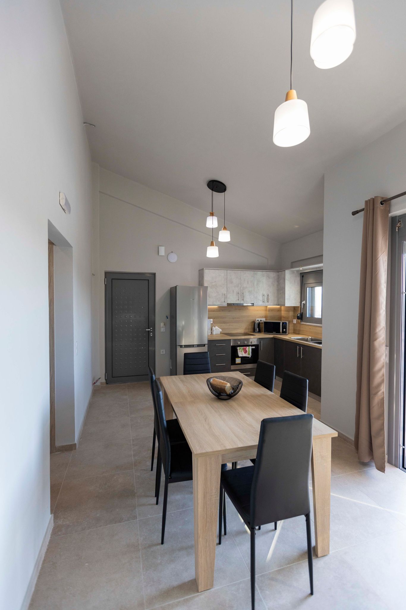 A modern kitchen with a dining area.