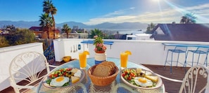 A dining table with breakfast items and a view of mountains. - Dayos Unique Suites (Eilat)