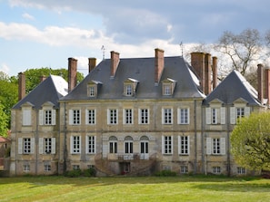 A large, historic building with multiple windows and a central entrance. - Château des Noces (Bazoges-en-Pareds)
