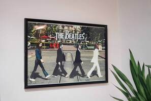 A framed picture of The Beatles on a wall. - Woodapple Residency (New Delhi)
