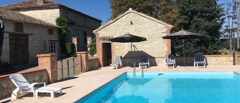 Seasonal outdoor pool, open 8 AM to 8 PM, pool umbrellas, pool loungers