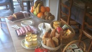 Un buffet de petit-déjeuner proposant une variété d'aliments, notamment des fruits, des viennoiseries et des produits laitiers.