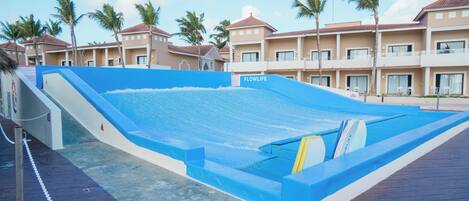 A swimming pool with a blue border, a slide, and a sign that reads 'FLOWLIFE.'