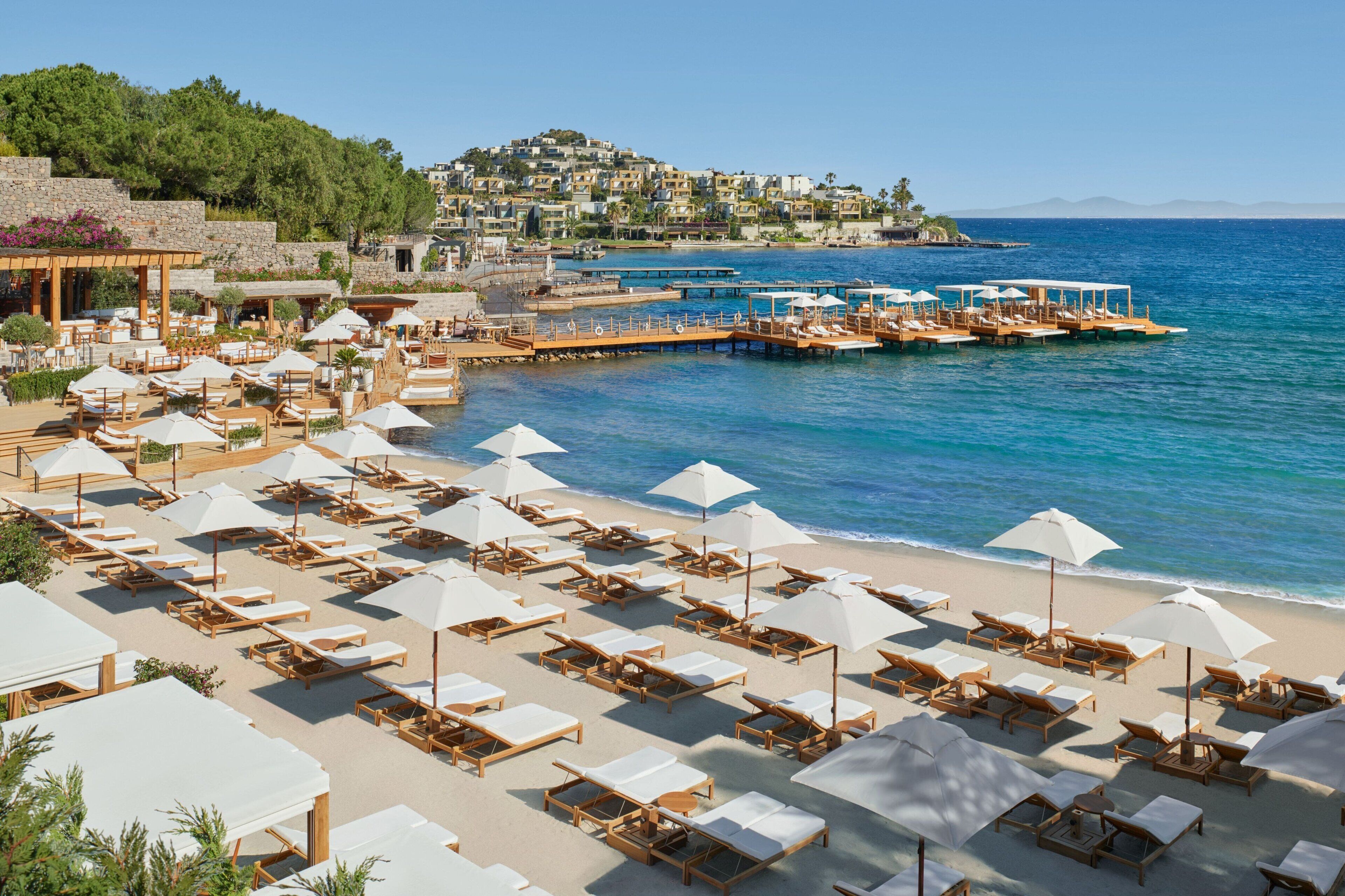 on the beach, white sand, beach cabanas, sun-loungers