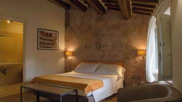 Une chambre à coucher avec un lit, une table de chevet et un mur orné d’une affiche.