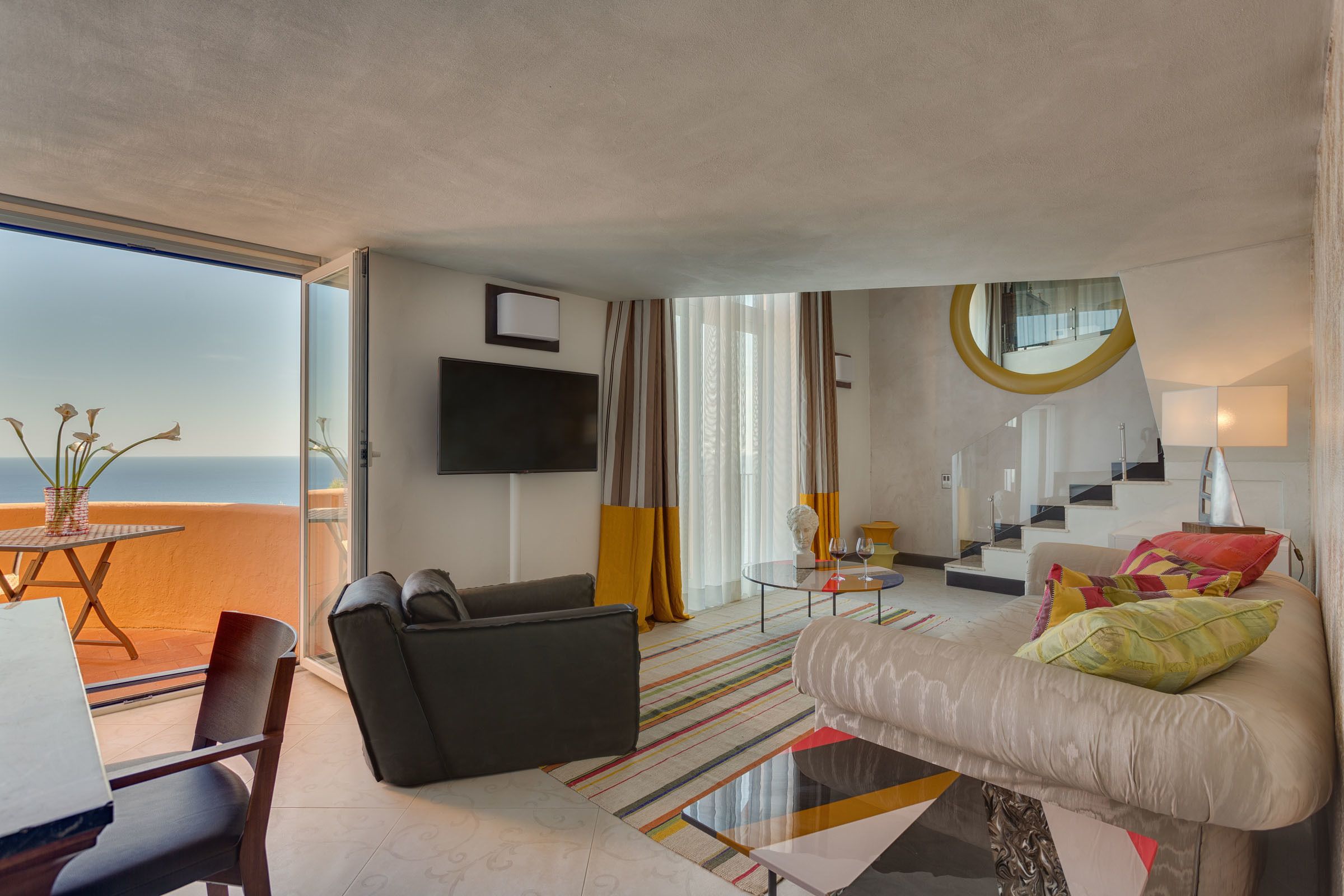junior suite, balcony, sea view | living area | flat-screen tv
