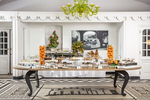 A buffet table with various food items and a decorative cactus plant.