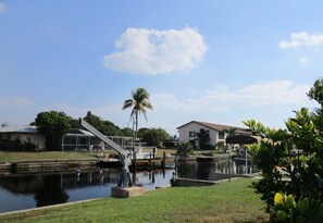 A residential area with a swimming pool, a bridge, and houses.