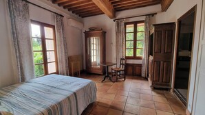 A bedroom with a bed, a chair, a table, and a window. - Residence with character (Pont-Saint-Esprit)