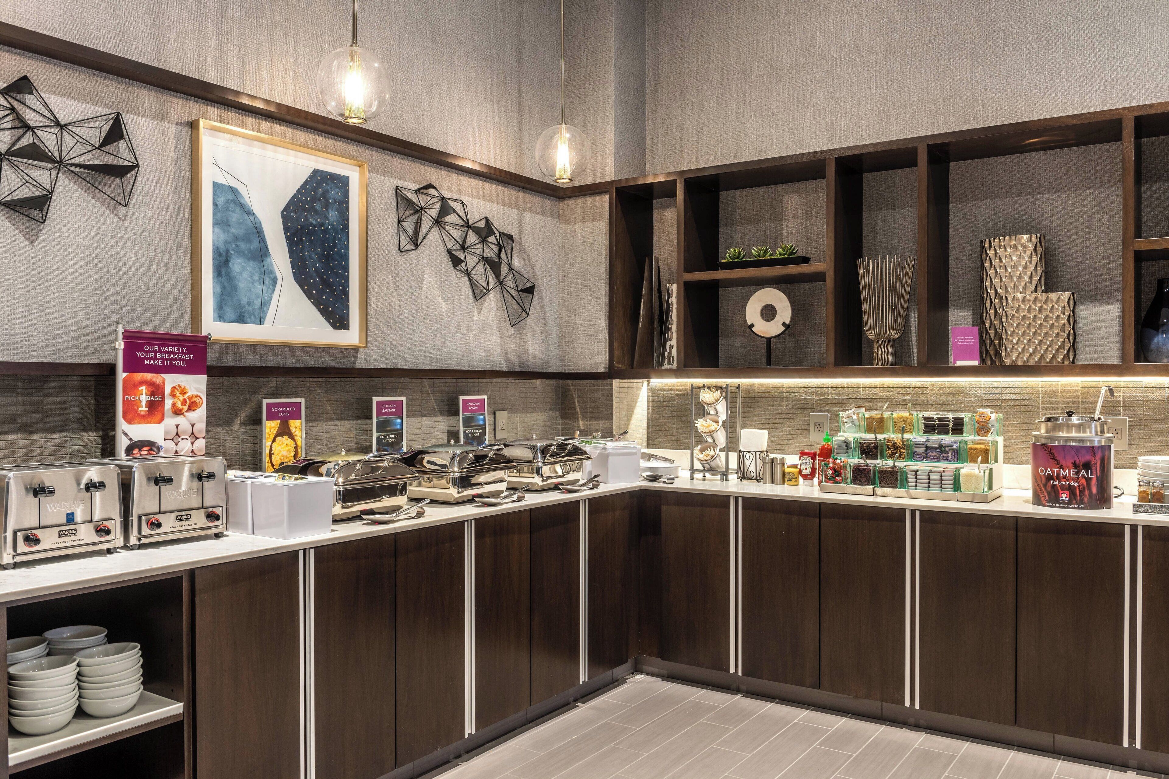 A modern breakfast bar with a variety of food options, including a coffee station and a selection of cereals.