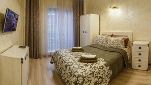 A hotel room with a bed, a wardrobe, a TV, and a desk. - FAVAR Carpathians (Skhidnytsia)