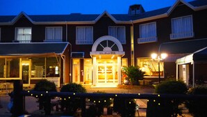 A hotel with a central entrance, multiple windows, and outdoor seating areas. - View Lodge Biwa (Otsu)