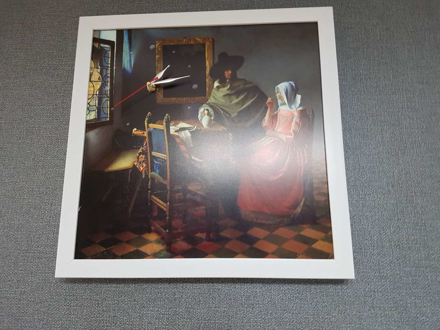 A framed artwork depicting a historical scene with a bed, a chair, and a table.
