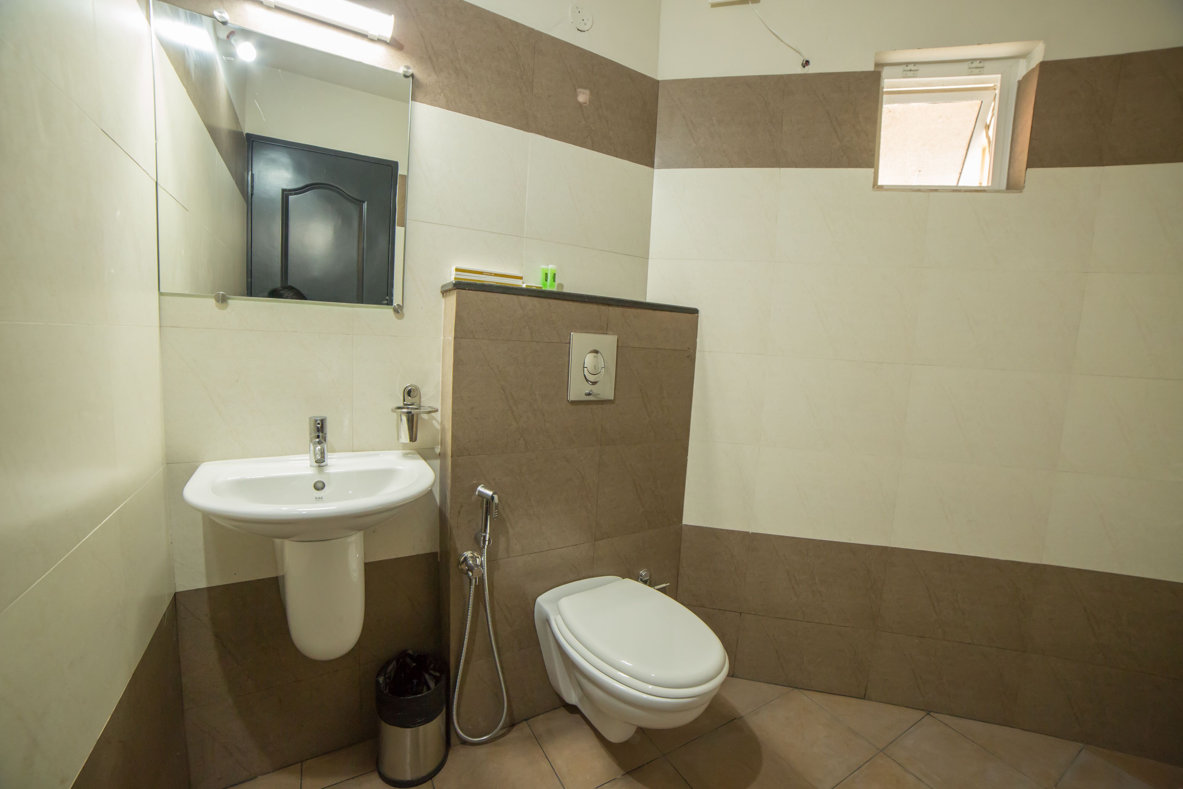 A bathroom with a sink, toilet, and shower.