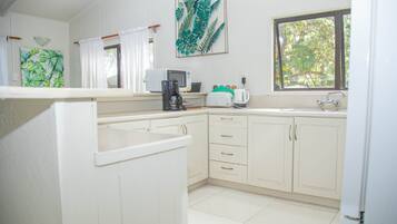 Superior Bungalow, 2 Bedrooms, Lagoon View, Beachfront | Private kitchen | Full-size fridge, microwave, oven, stovetop