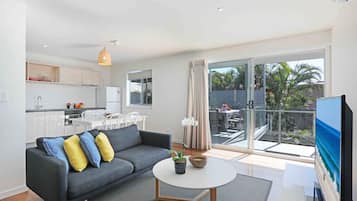 Deluxe Apartment, 2 Bedrooms | Living room | Flat-screen TV