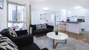 Eine moderne Wohnung mit Wohnzimmer, Küche und Essbereich.