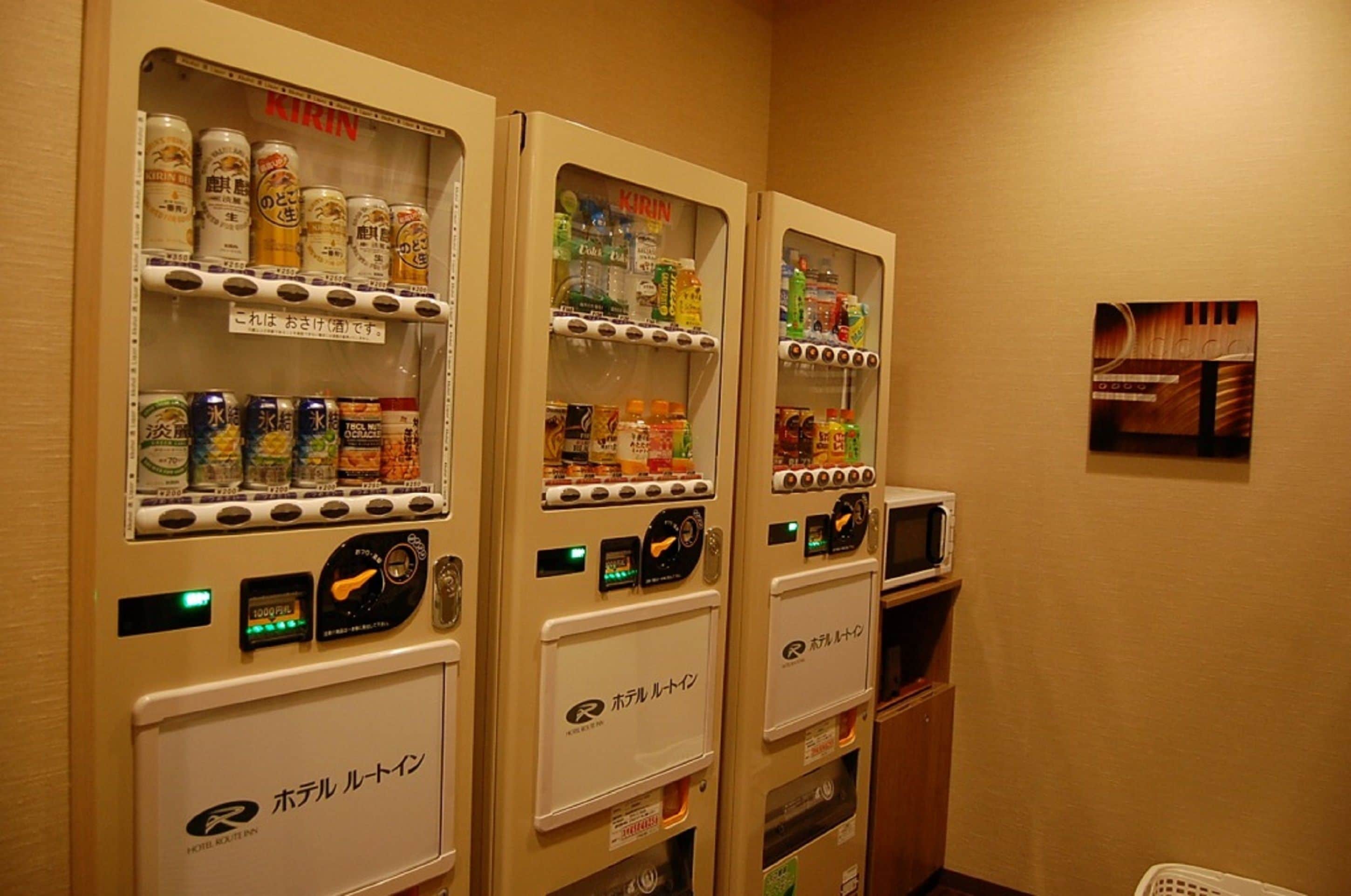 Vending machines with beverages and snacks in a hotel setting.
