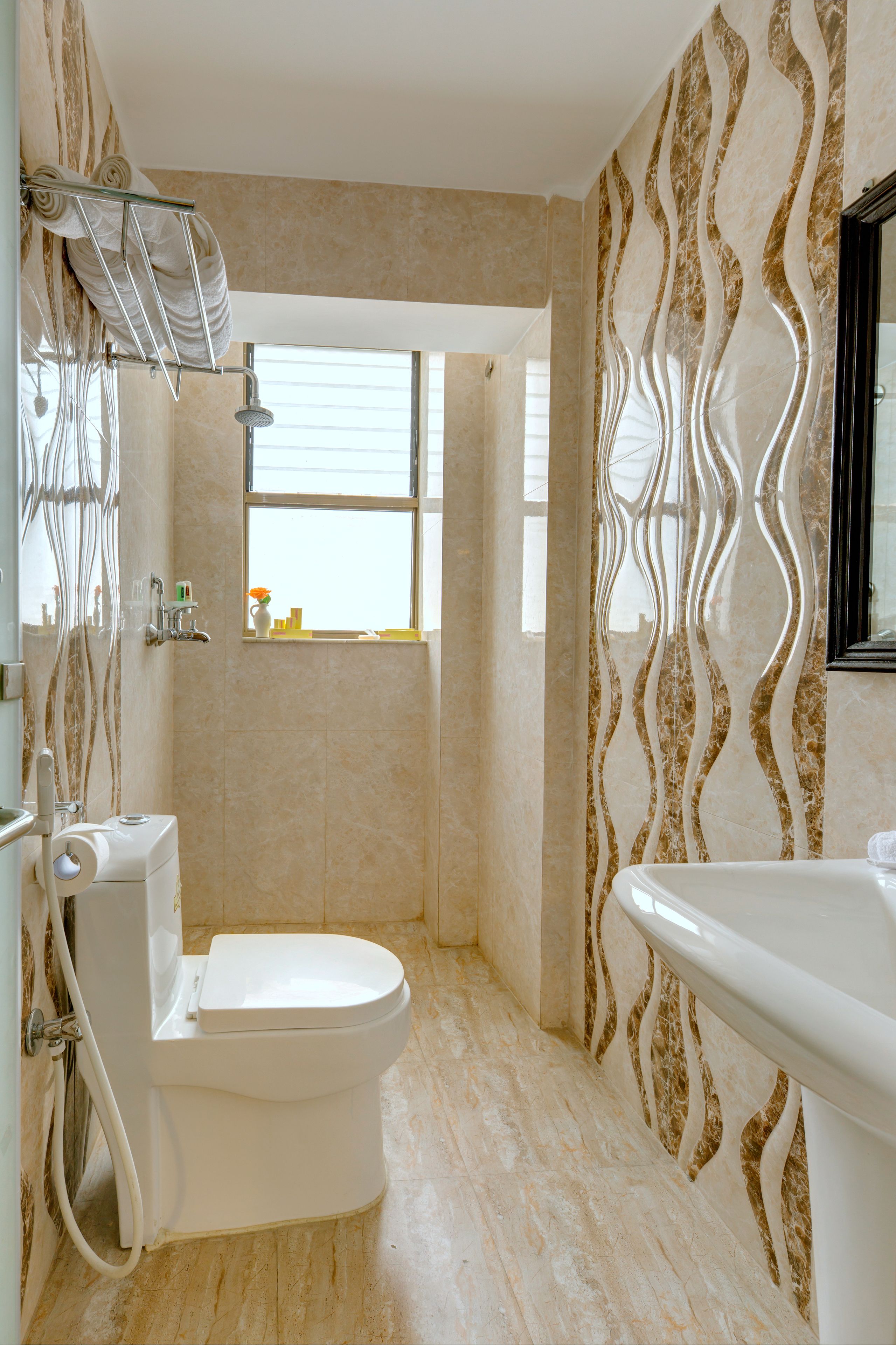 A bathroom with a toilet, shower, and sink.