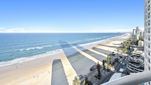Un paisaje urbano costero con playa, rascacielos y cielo despejado.