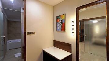 A bathroom with a shower, a toilet, and a sink.