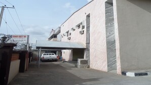 A building with a sign for 'CHINOX GUEST INN' and a reception area. - Chinox Guest Inn (Abuja)