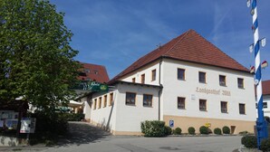 A building with a red roof and white walls, labeled "Landgasthof 2018".