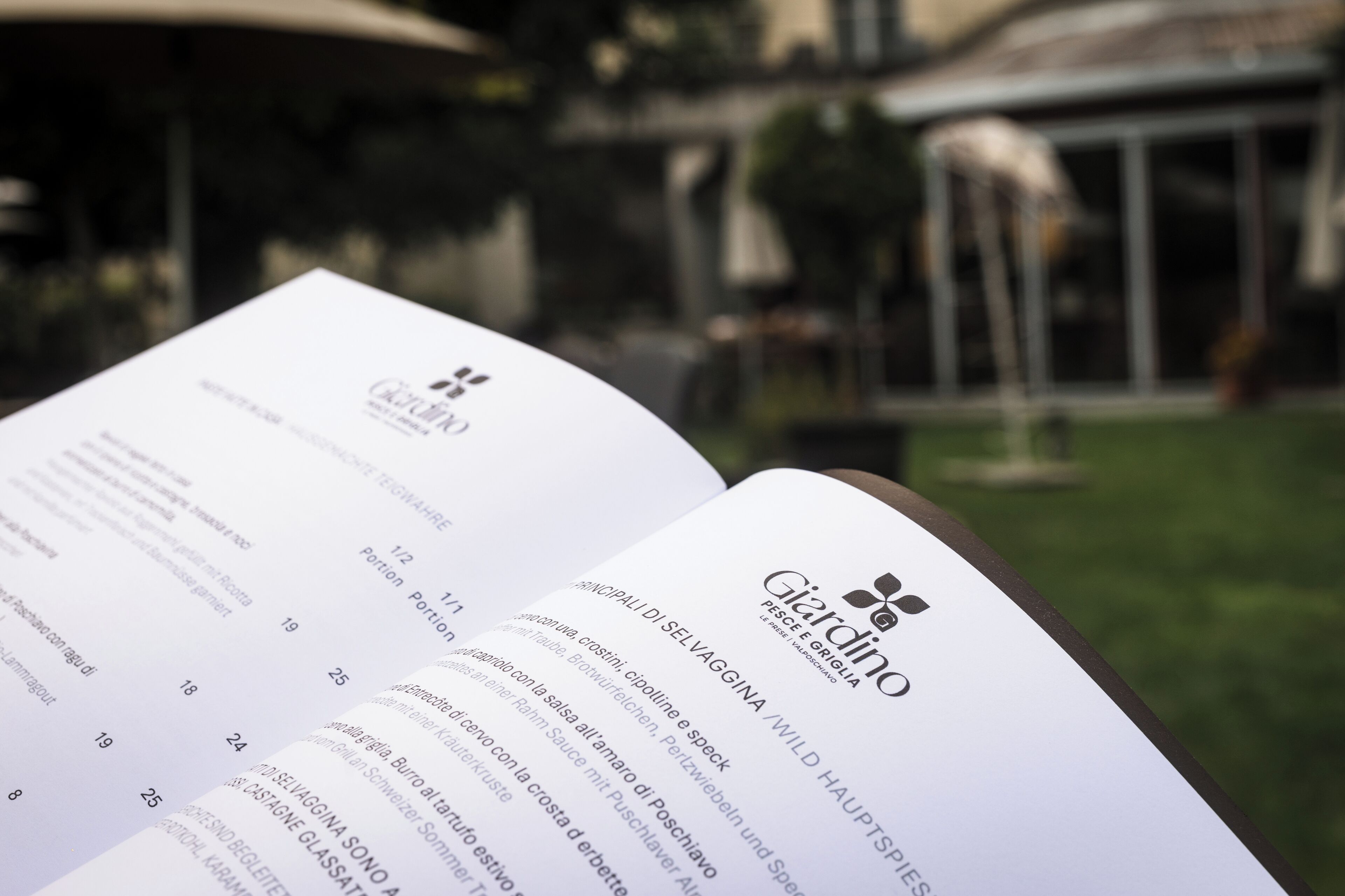 An open menu page of a restaurant with a logo and menu items listed.