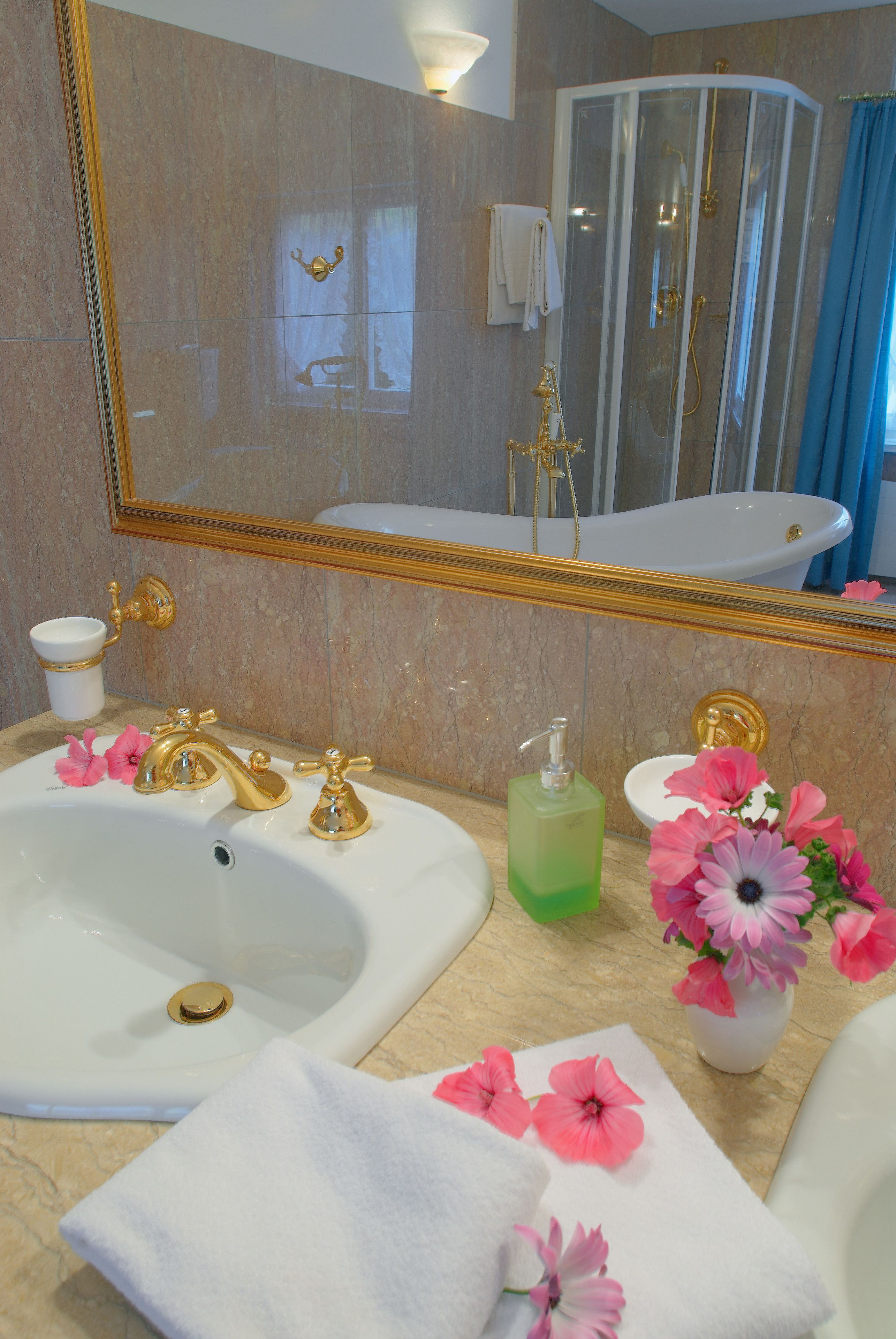 A bathroom with two sinks, a shower, and a mirror.