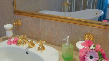 A bathroom with two sinks, a shower, and a mirror.