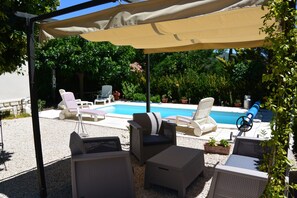 حمّام سباحة خارجي، مظلات على حمّام السباحة، مقاعد للتشمس