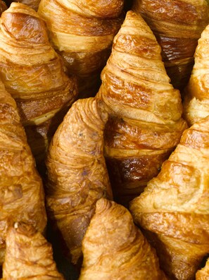 A close-up of golden-brown pastries with a flaky texture.