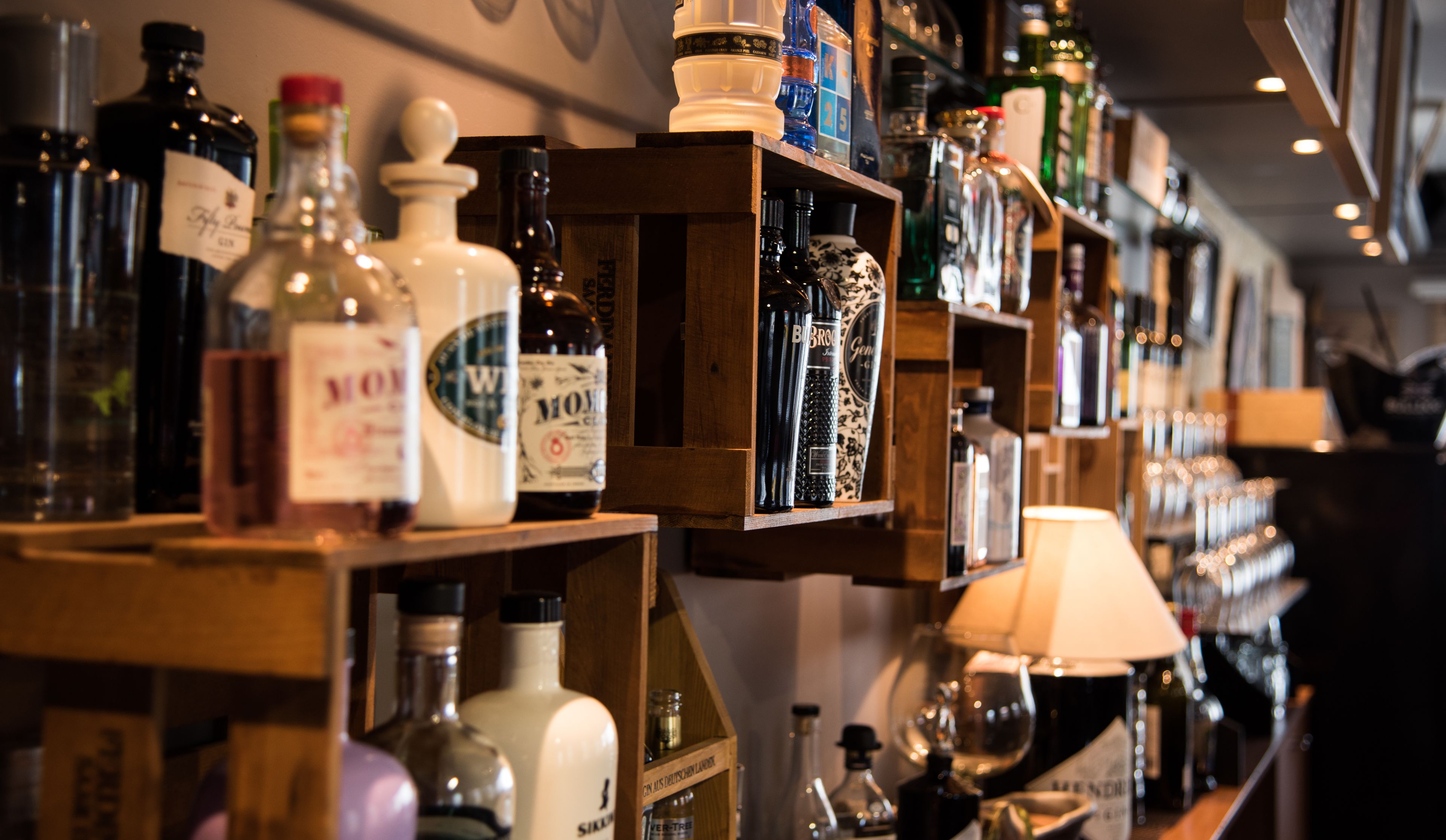 A bar with shelves of various liquor bottles.