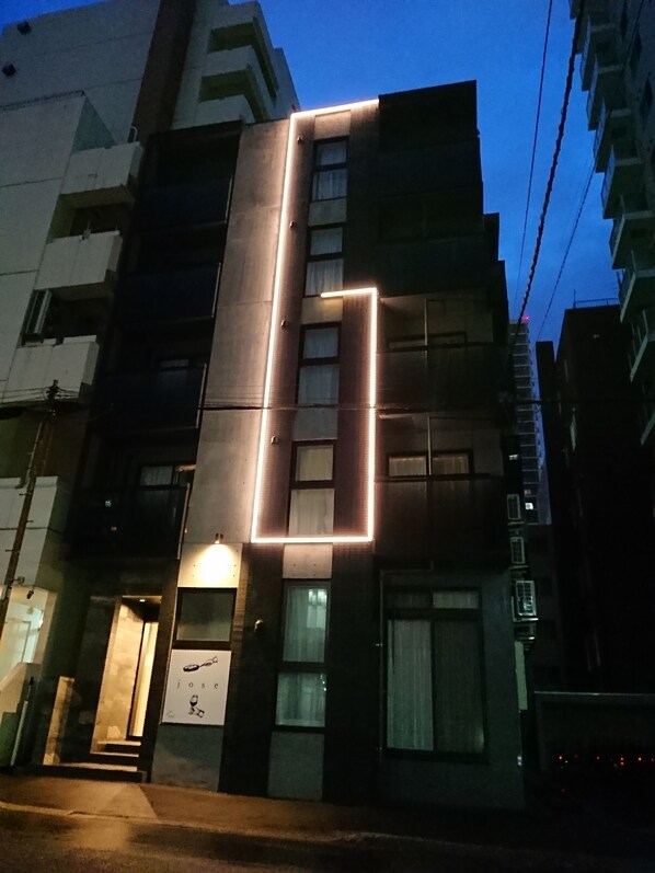 A multi-story building with a prominent vertical light strip on the facade.
